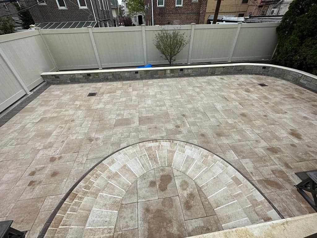 After: new light pavers across the same backyard