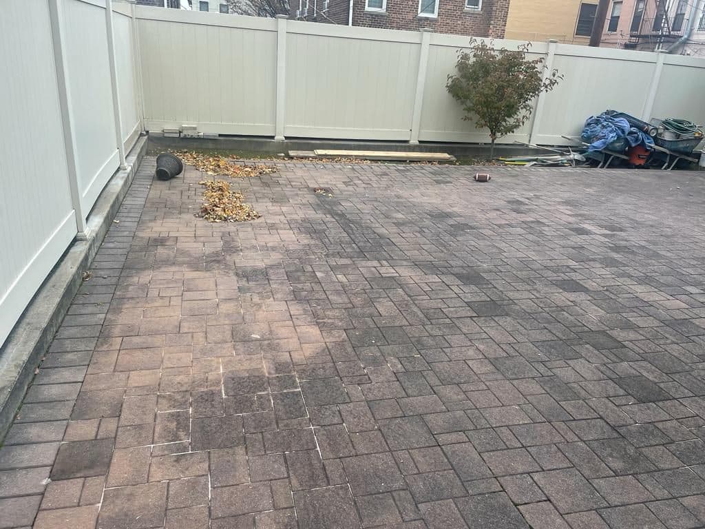 Before: old dark pavers in the backyard