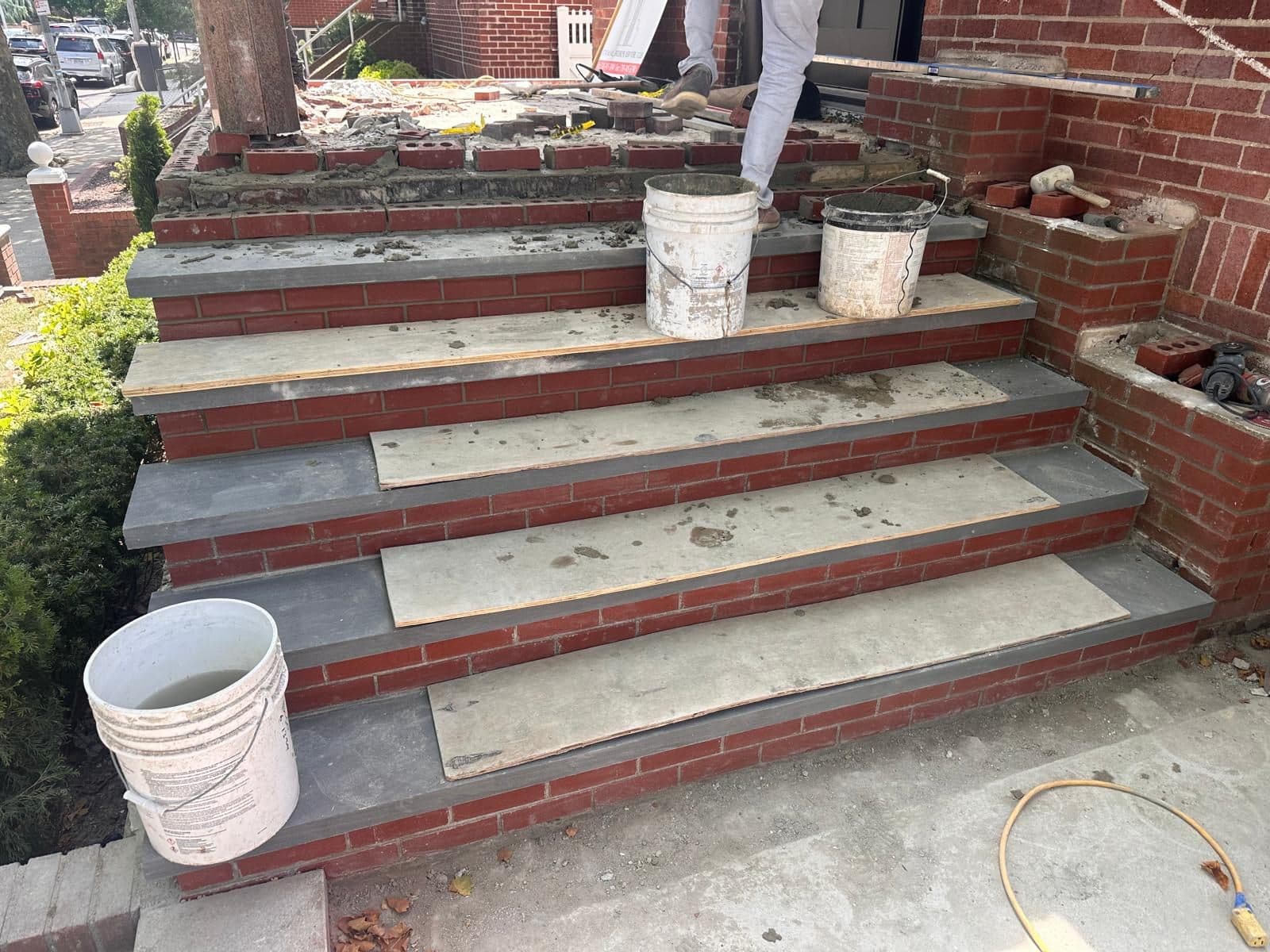 New stone treads being set on the front steps