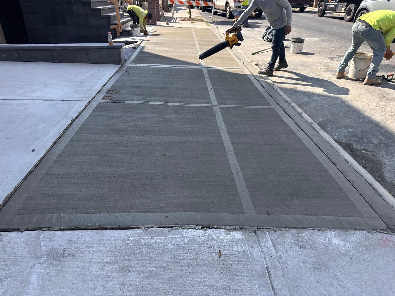 Crew finishing the new concrete driveway