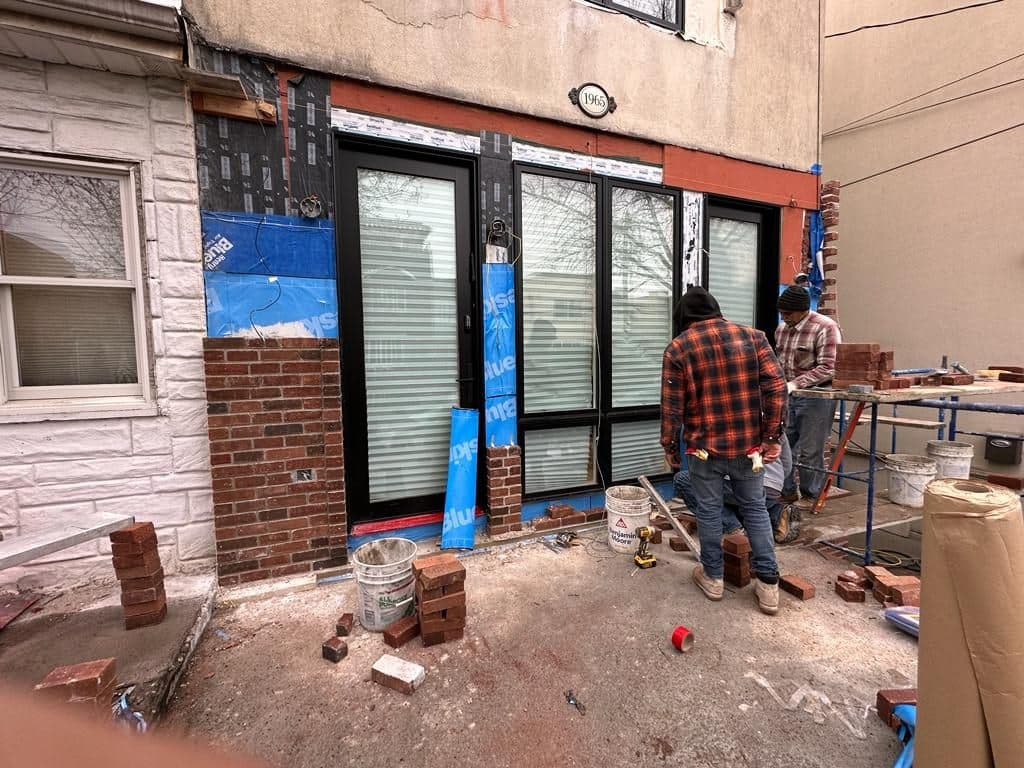 Crew laying the new brick facade around the front windows