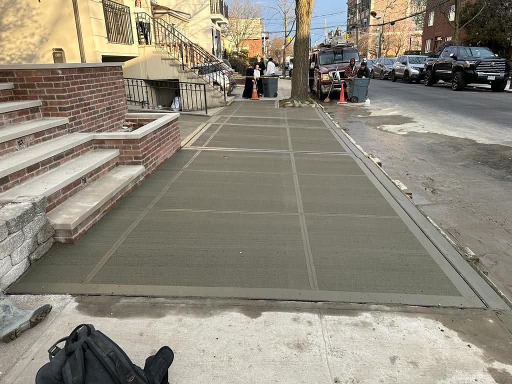 New concrete sidewalk in front of the house