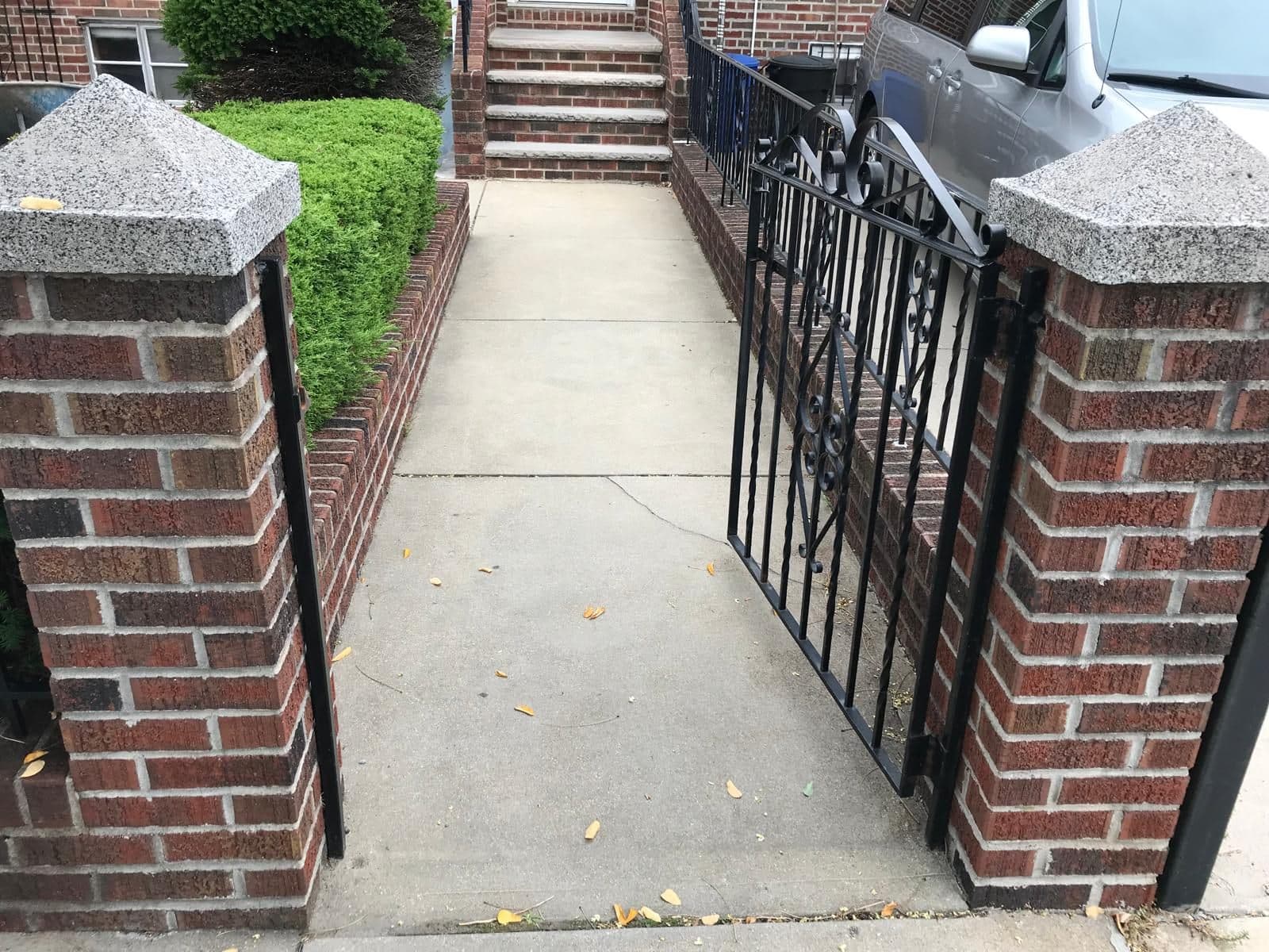 Before: plain concrete walk between brick pillars