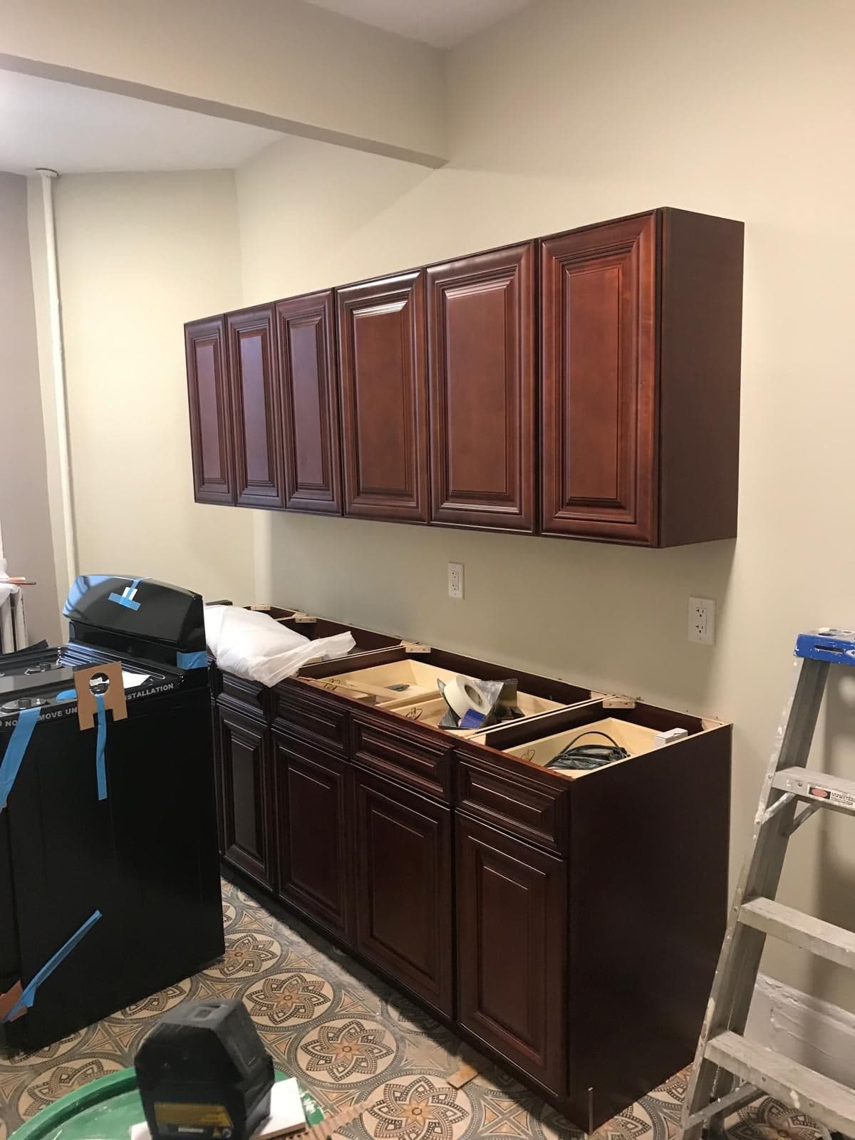 New kitchen cabinets being installed in a Brooklyn apartment