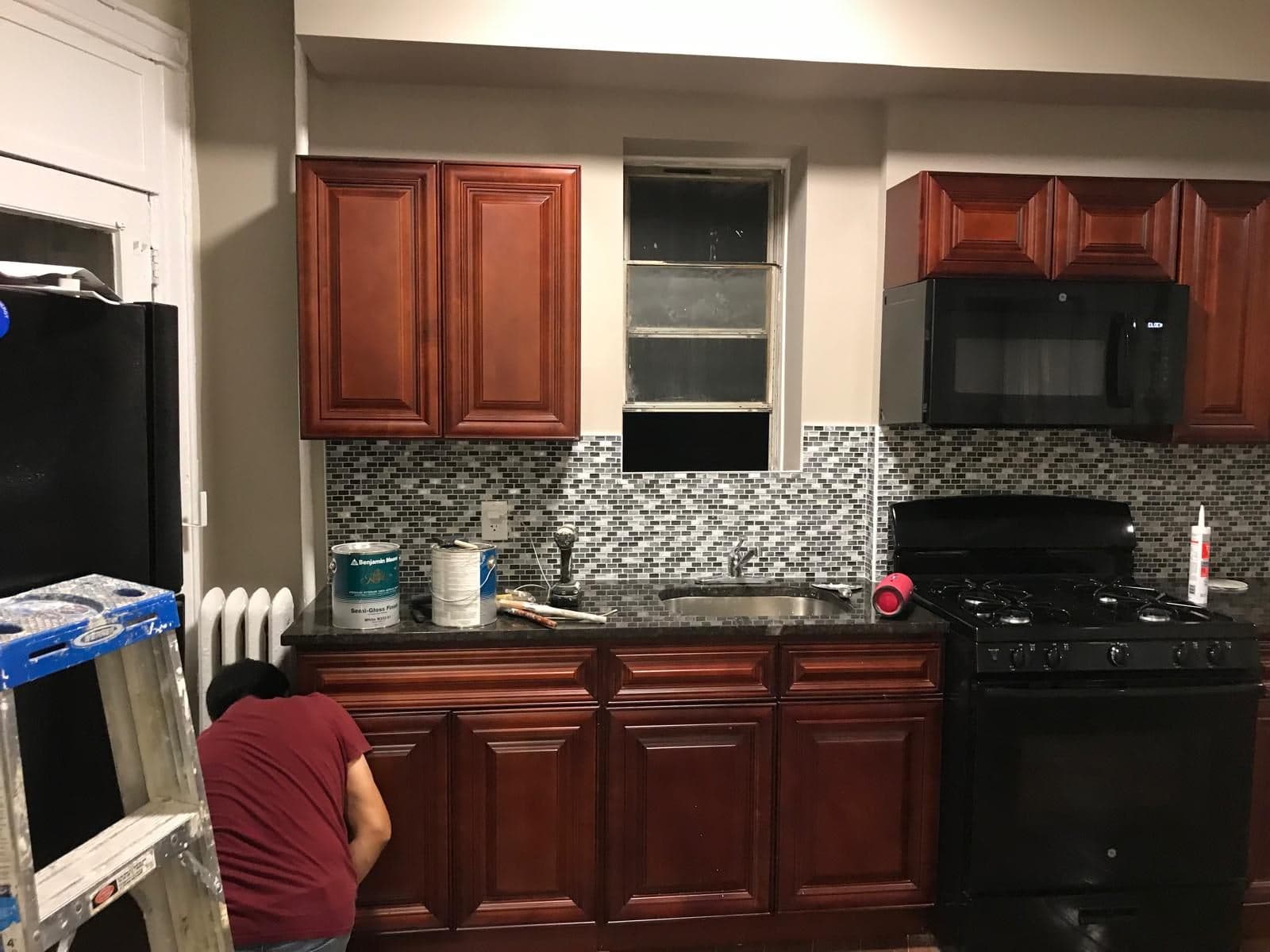 New kitchen with cherry cabinets and a mosaic backsplash in a Brooklyn apartment