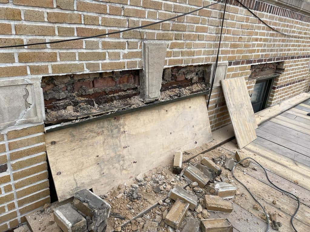 Old lintel exposed after the brick above a window was removed