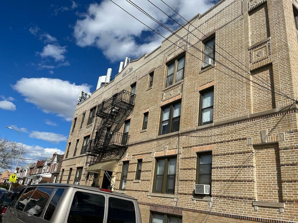 Four-story brick apartment building after the work