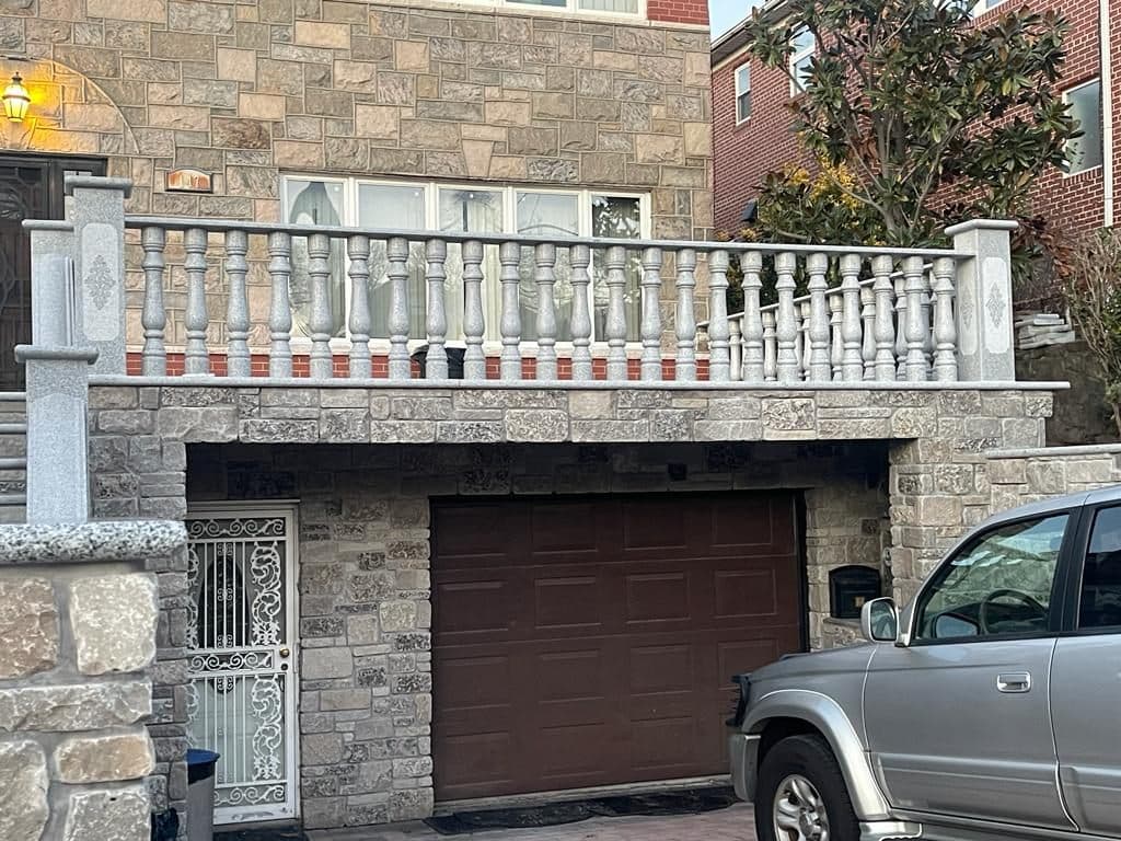 After: natural stone walls, balustrade and garage front
