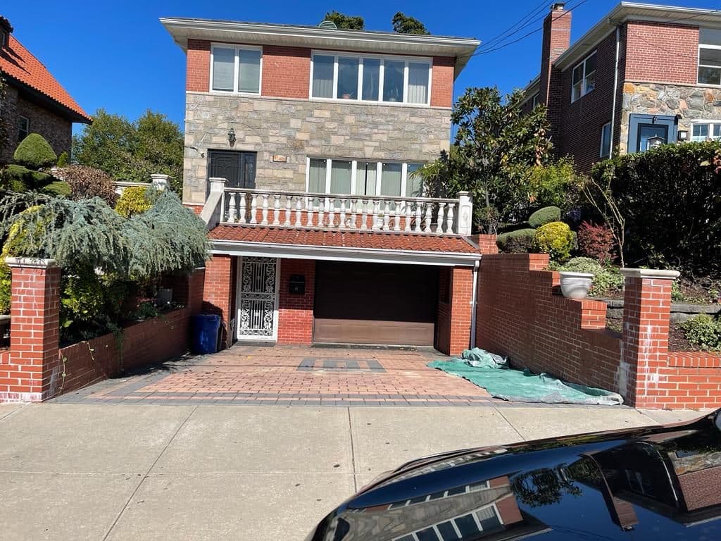 Before: house front with brick planters and old steps