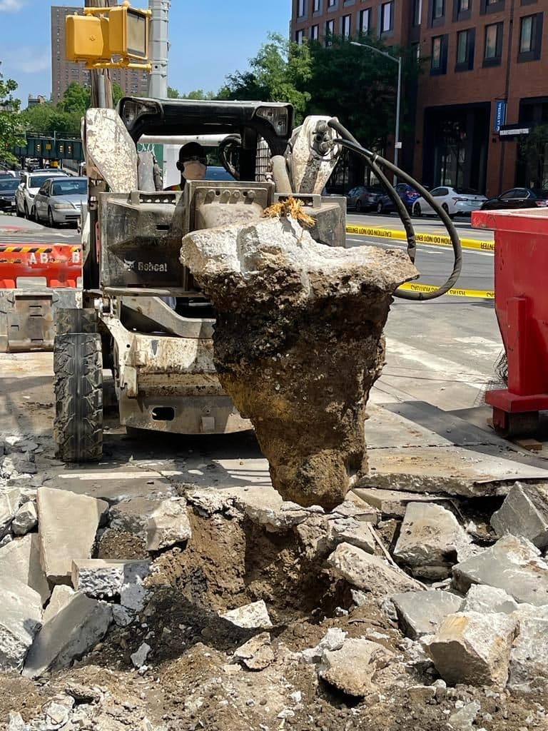 Skid steer breaking out the old sidewalk