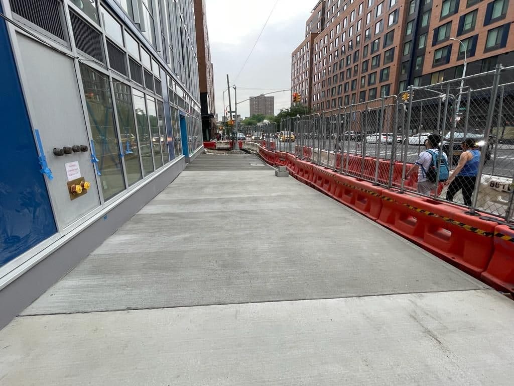 After: new concrete sidewalk along the building