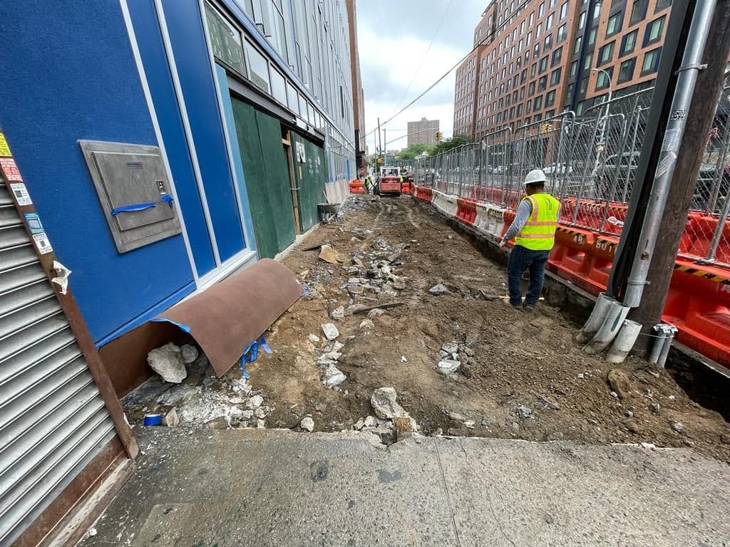 Before: sidewalk area dug out along the building