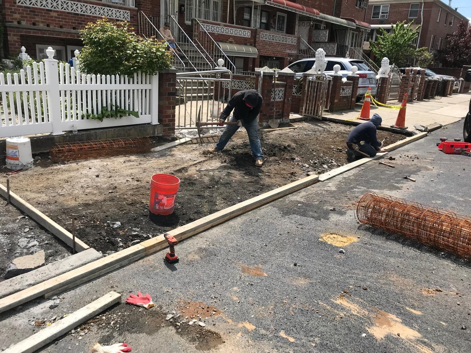 Crew setting wire mesh for a new sidewalk in Gravesend, Brooklyn