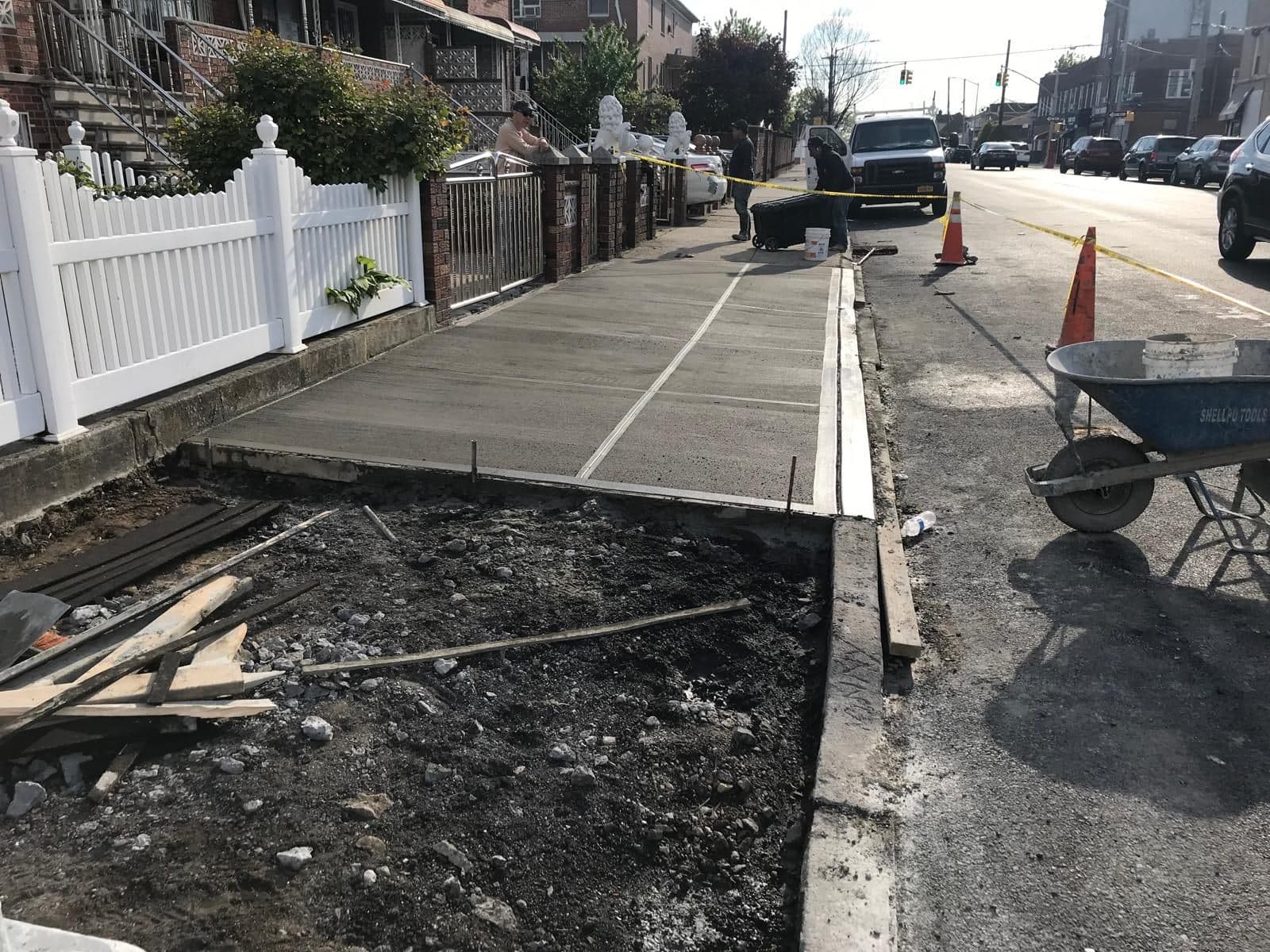 Freshly poured concrete finished along the fence line