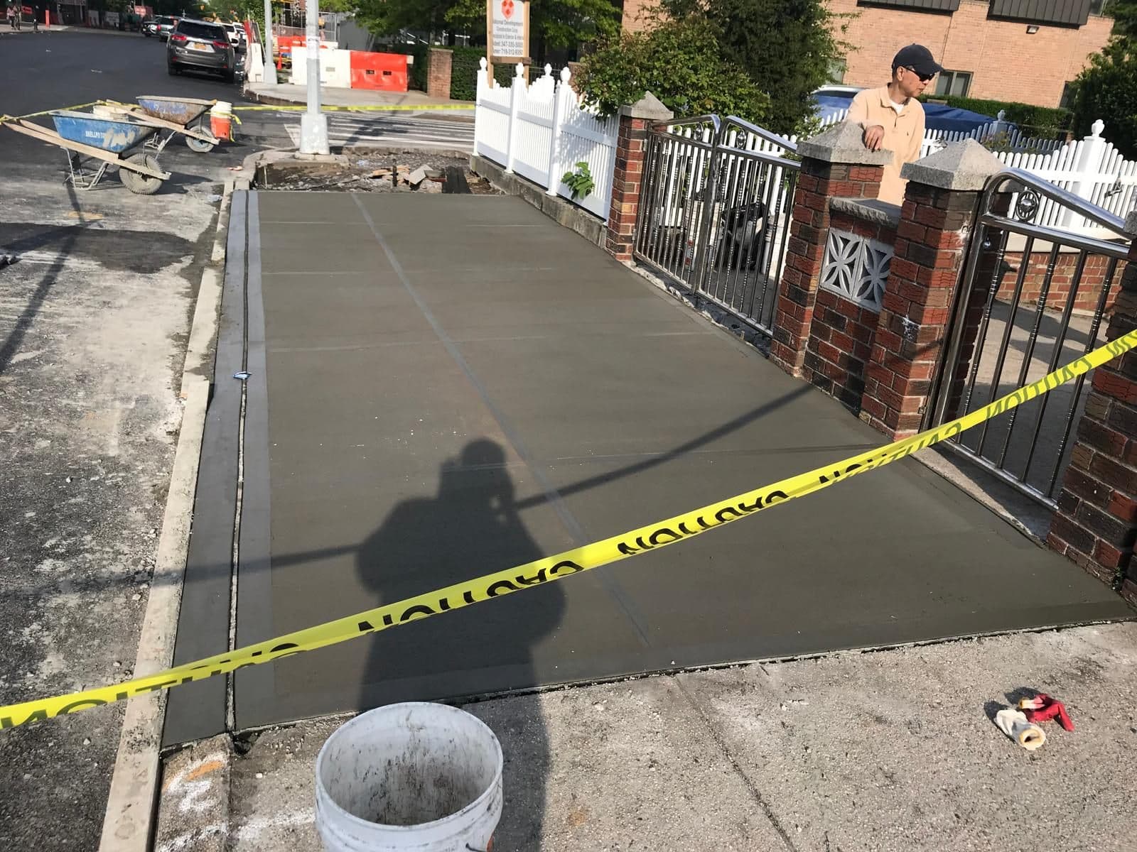 New sidewalk curing behind caution tape