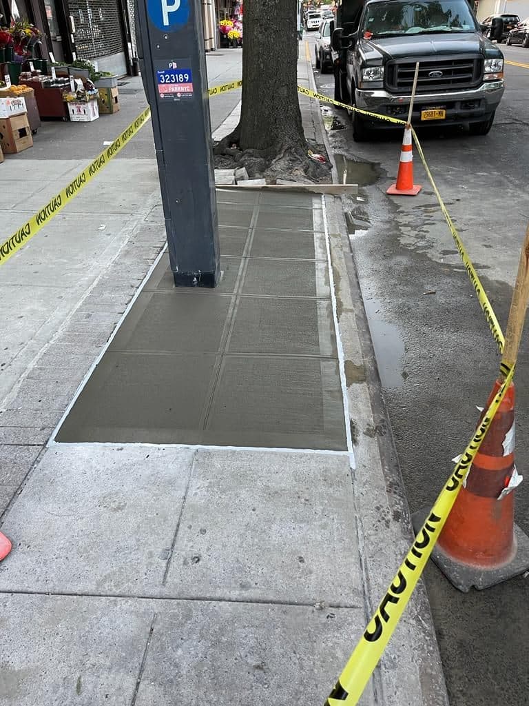 New concrete sidewalk flags beside a parking meter in Manhattan