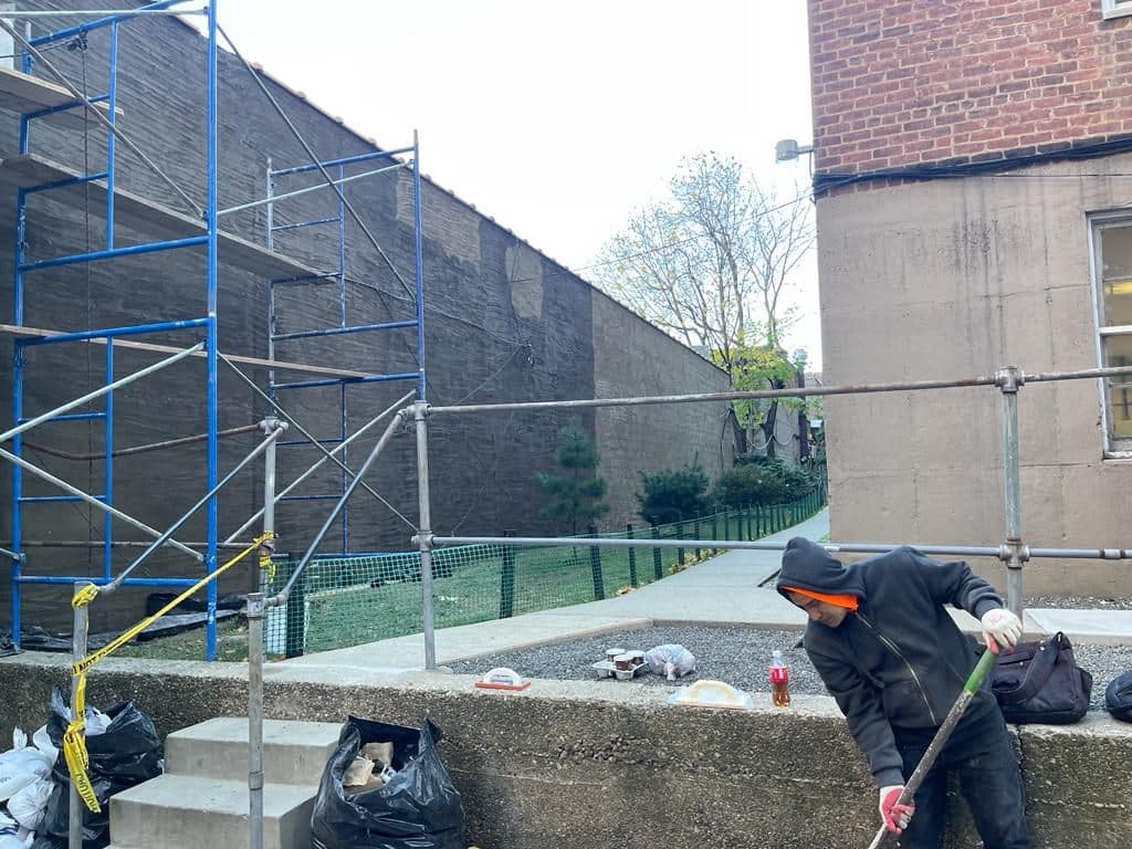 Crew building a wood frame in the low area of the roof