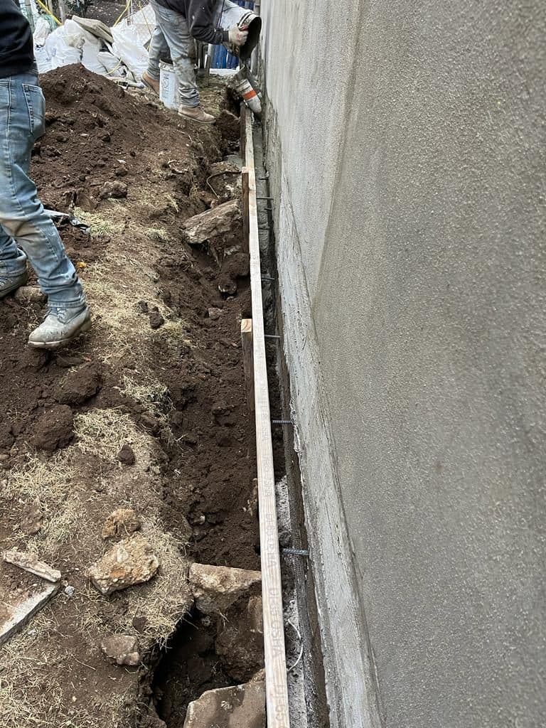 Worker rolling out new roofing membrane