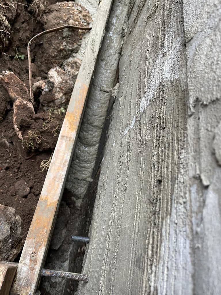 Wire mesh fastened at the base of the wall