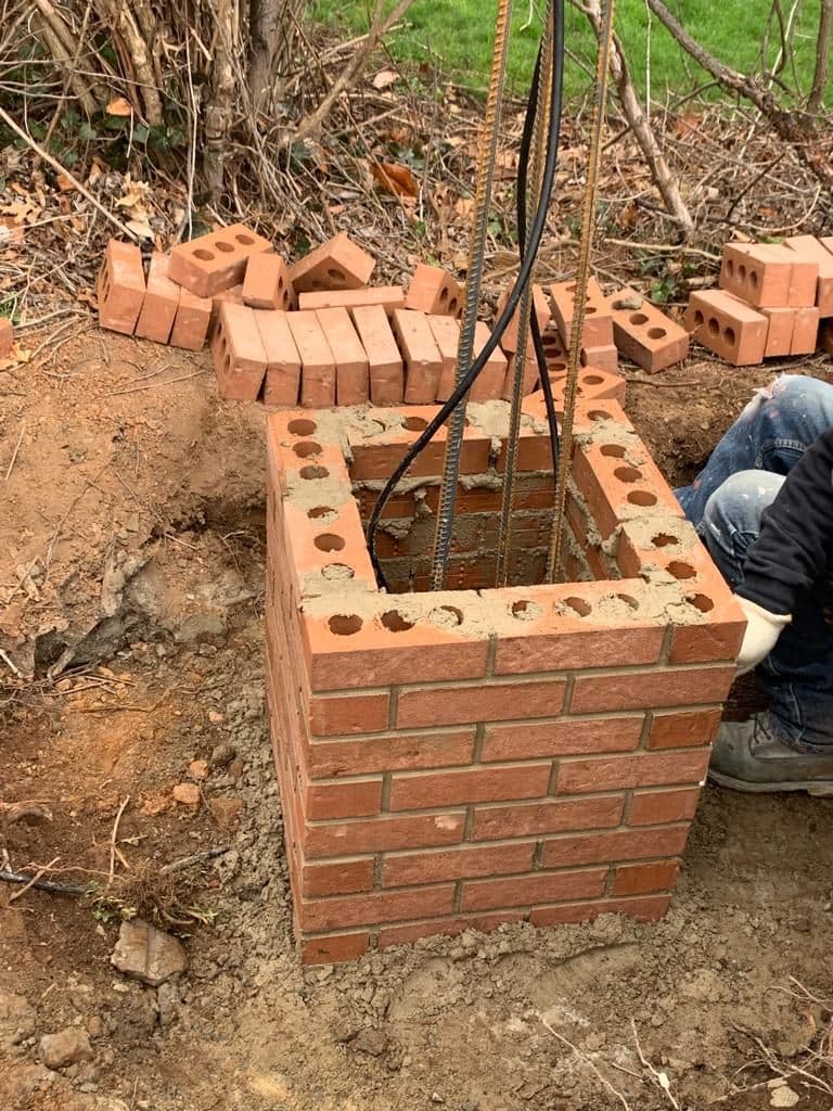 First courses of brick laid around the rebar
