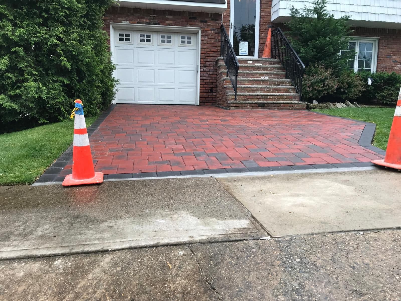 After: new red paver driveway with a dark border