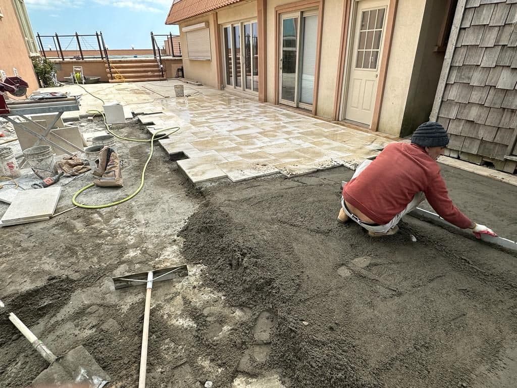Mason setting Jerusalem stone on a mortar bed