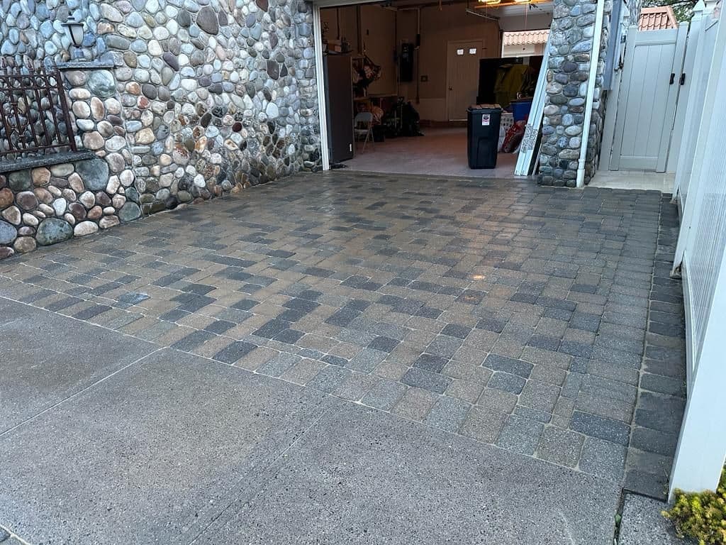 After: the same paver driveway cleaned and re-sanded