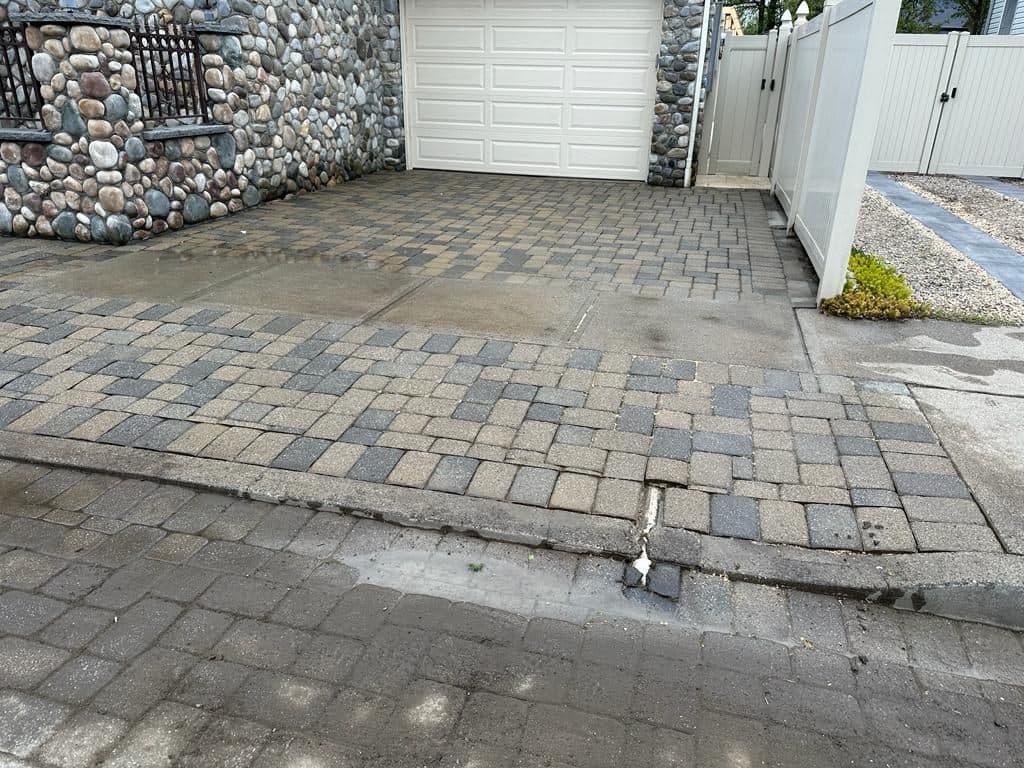 Before: dirty, stained paver driveway in front of the garage