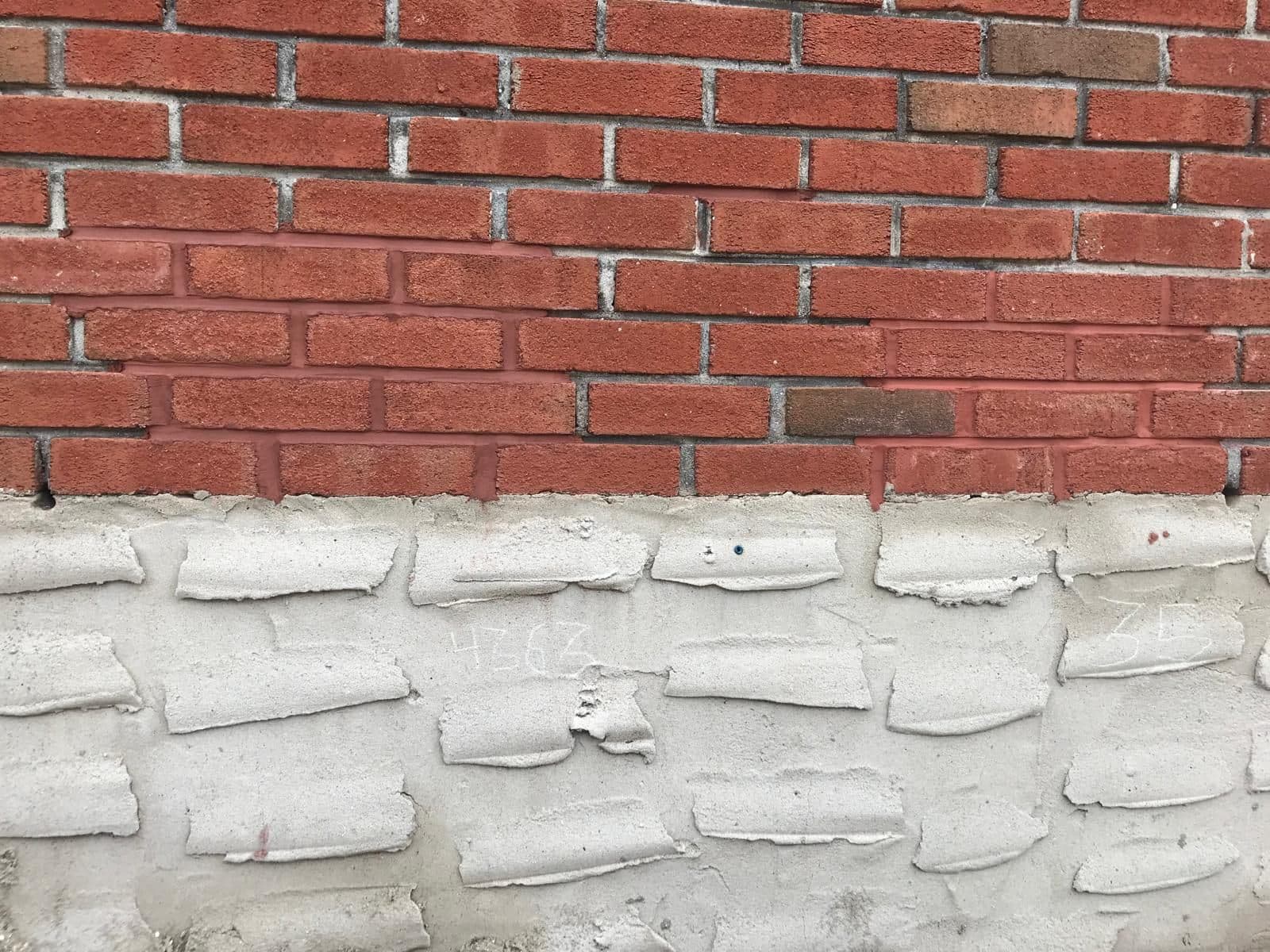 Brick with new pointing above and old mortar below