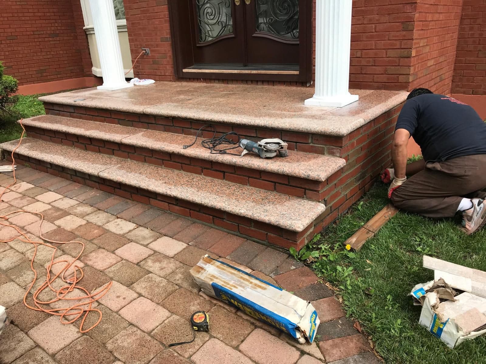 Mason setting new granite steps