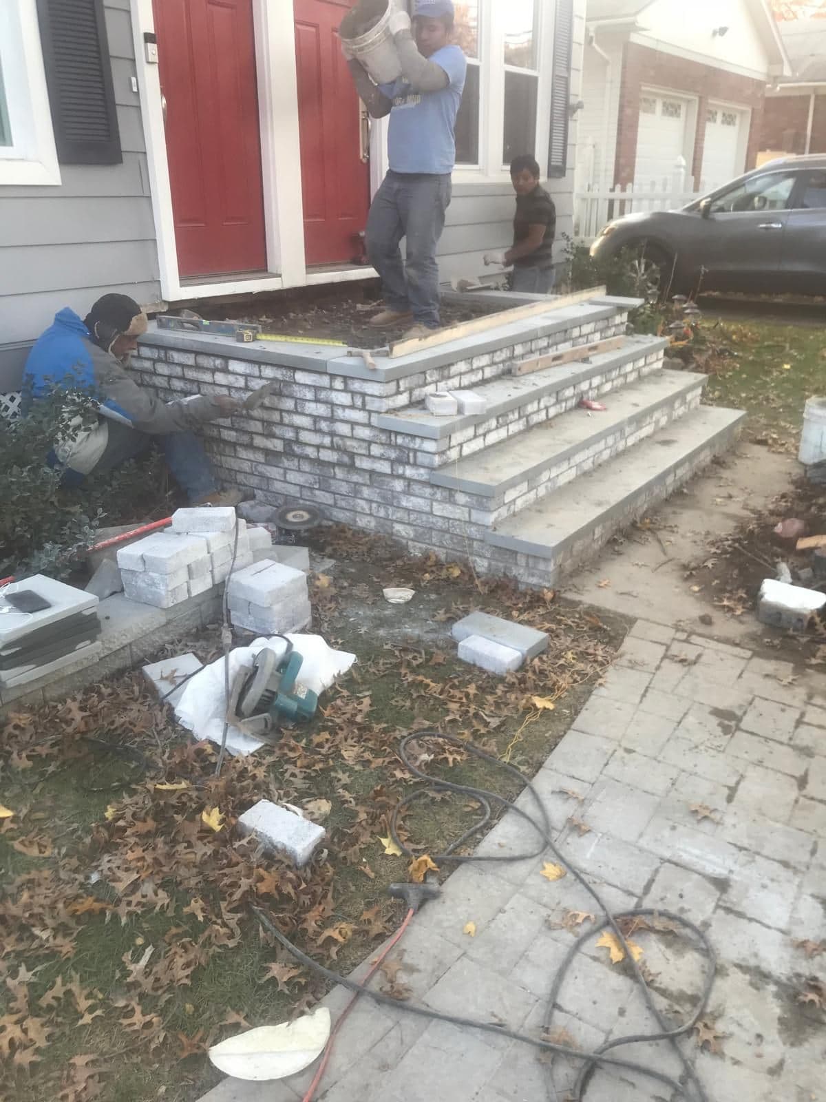 Stone veneer going onto the sides of the new steps