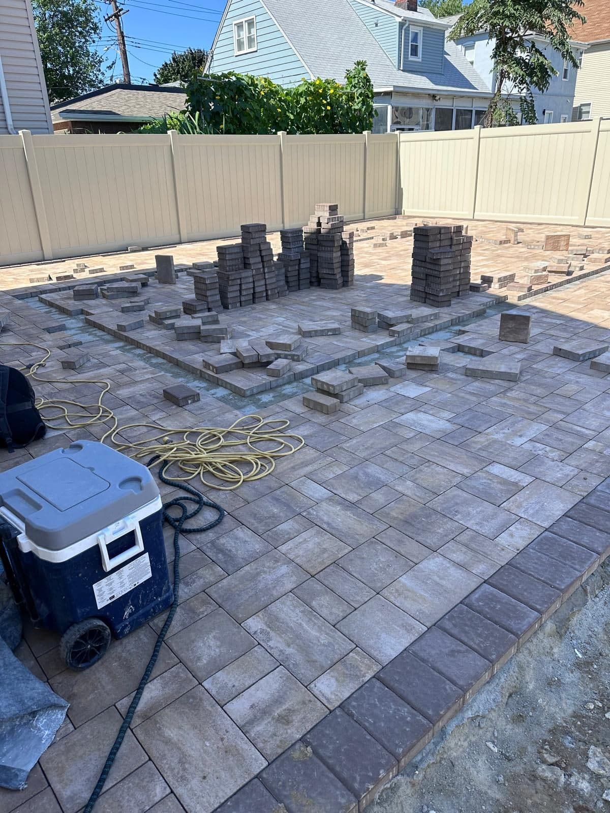 Pallets of pavers delivered to the backyard