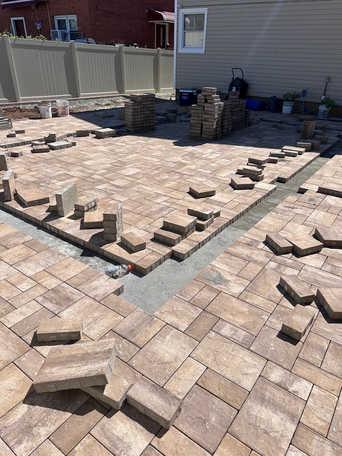 Pavers being laid in the backyard pattern