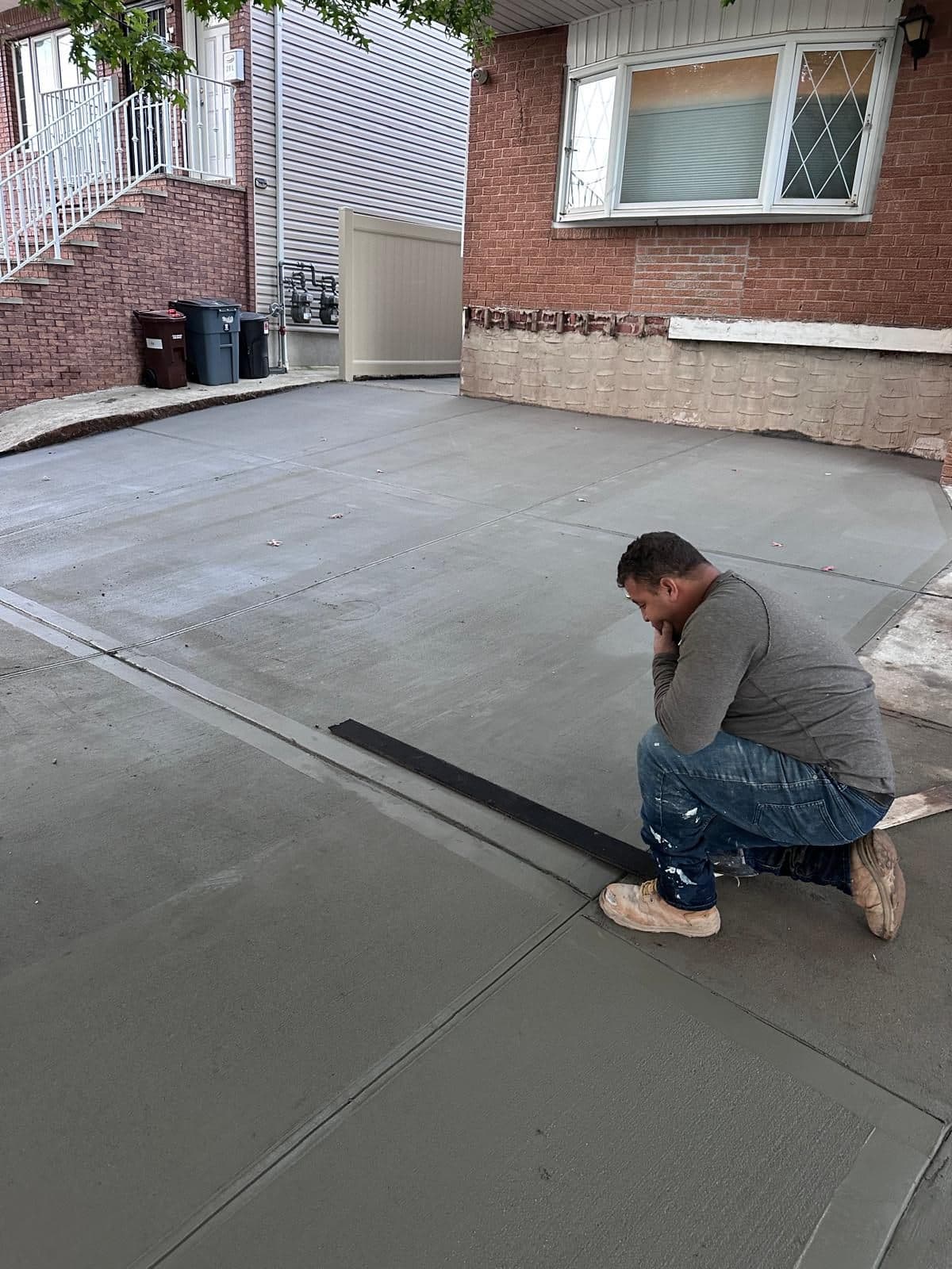 Crew finishing new concrete in the front yard
