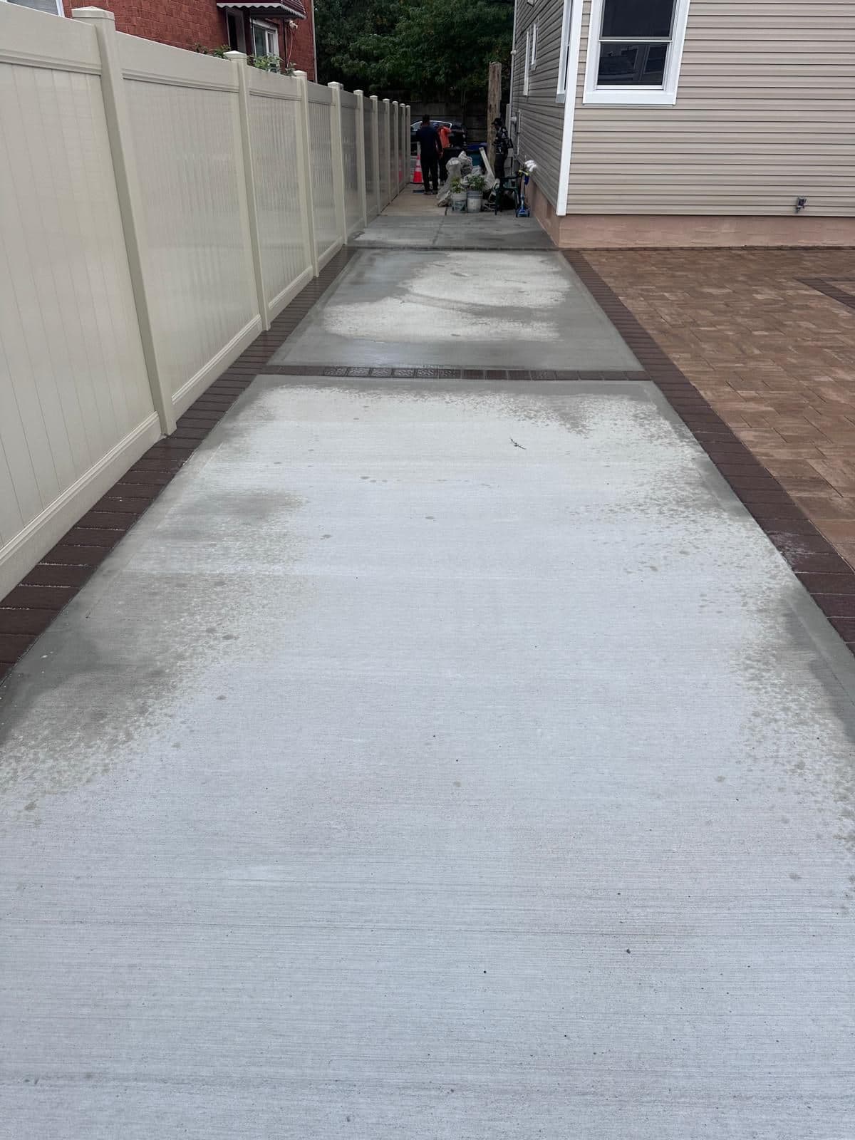 New concrete side path next to the paver area