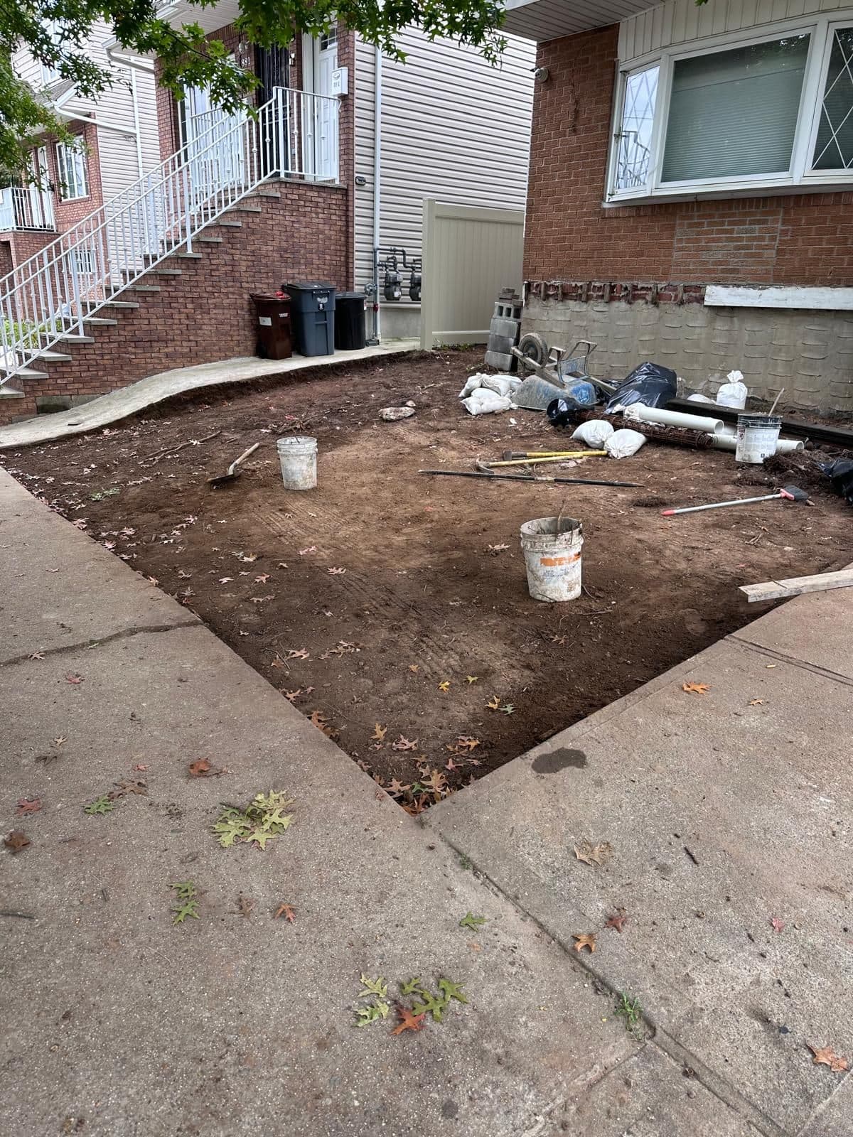 Before: bare dirt front yard beside the house